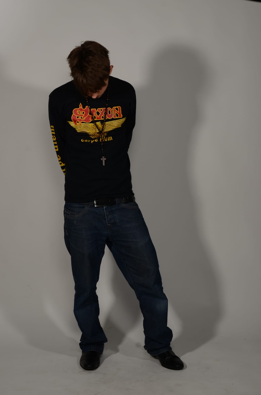 Frank Studley looking down in a black Saxon shirt
